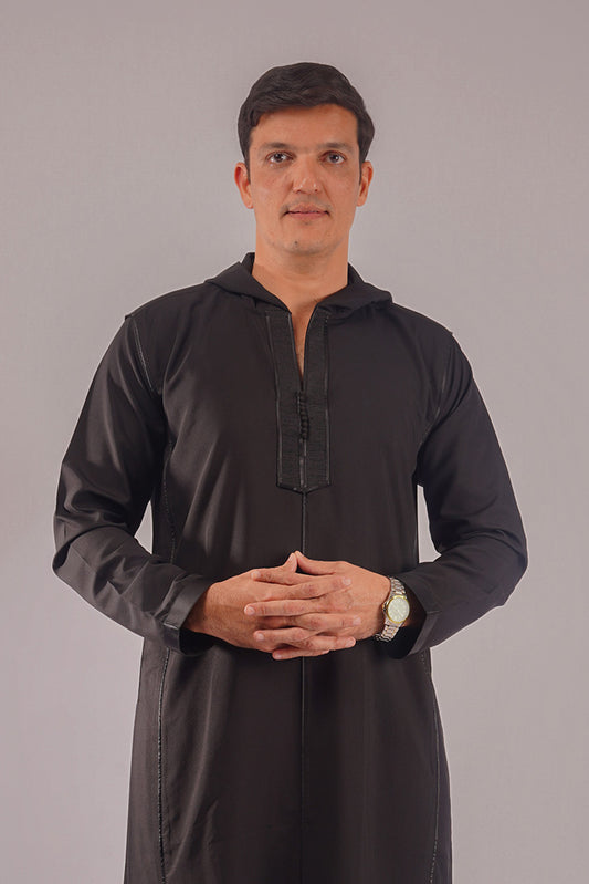 Man wearing Aamsah's Hooded Black Thobe, offering a stylish alternative to similar styles from Alqamees and MuslimAmerican.com.