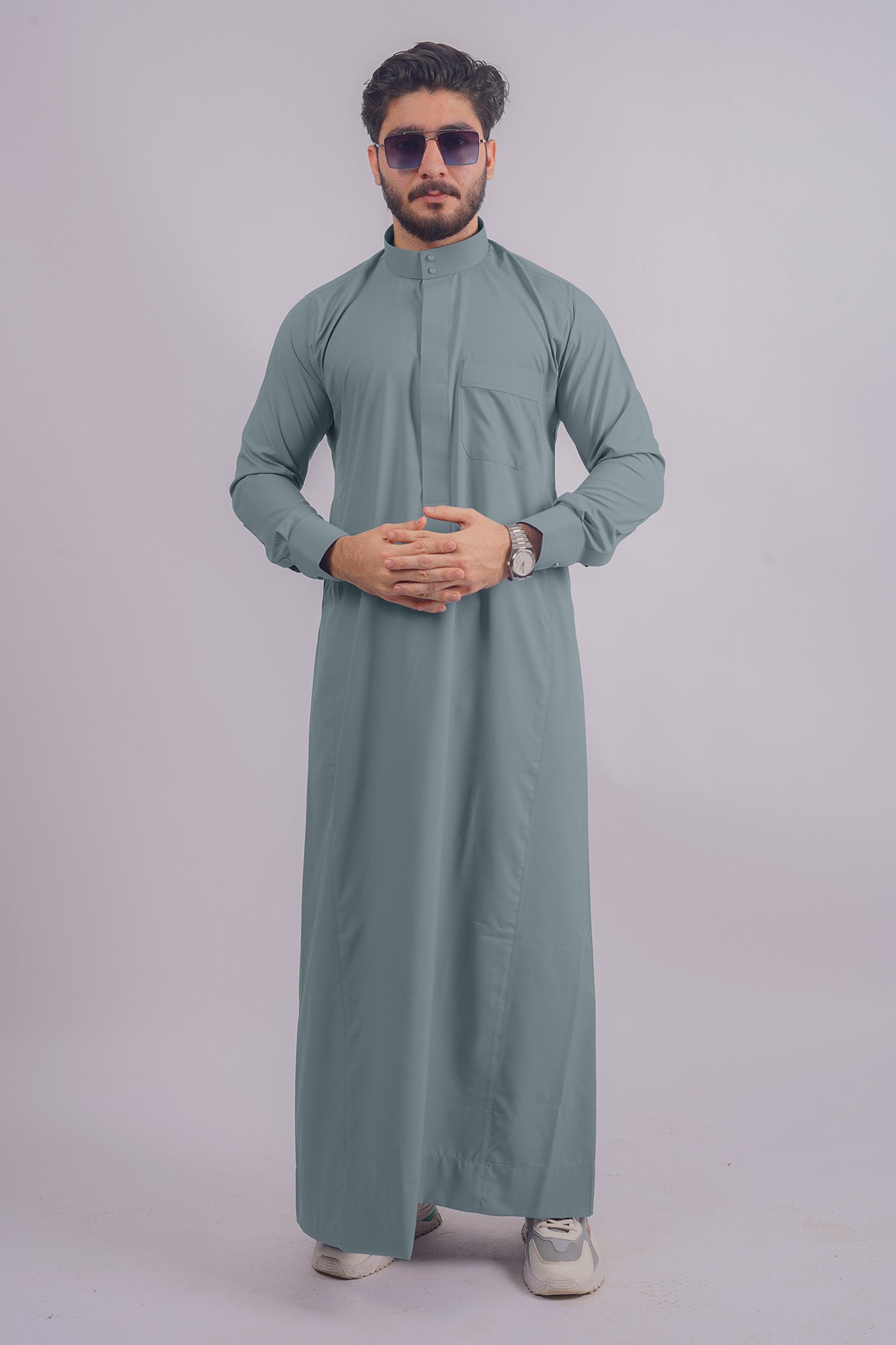 Sophisticated Dusty Blue Saudi Thobe by Aamsah, rivaling styles from Alqamees, tailored for modern and traditional settings.