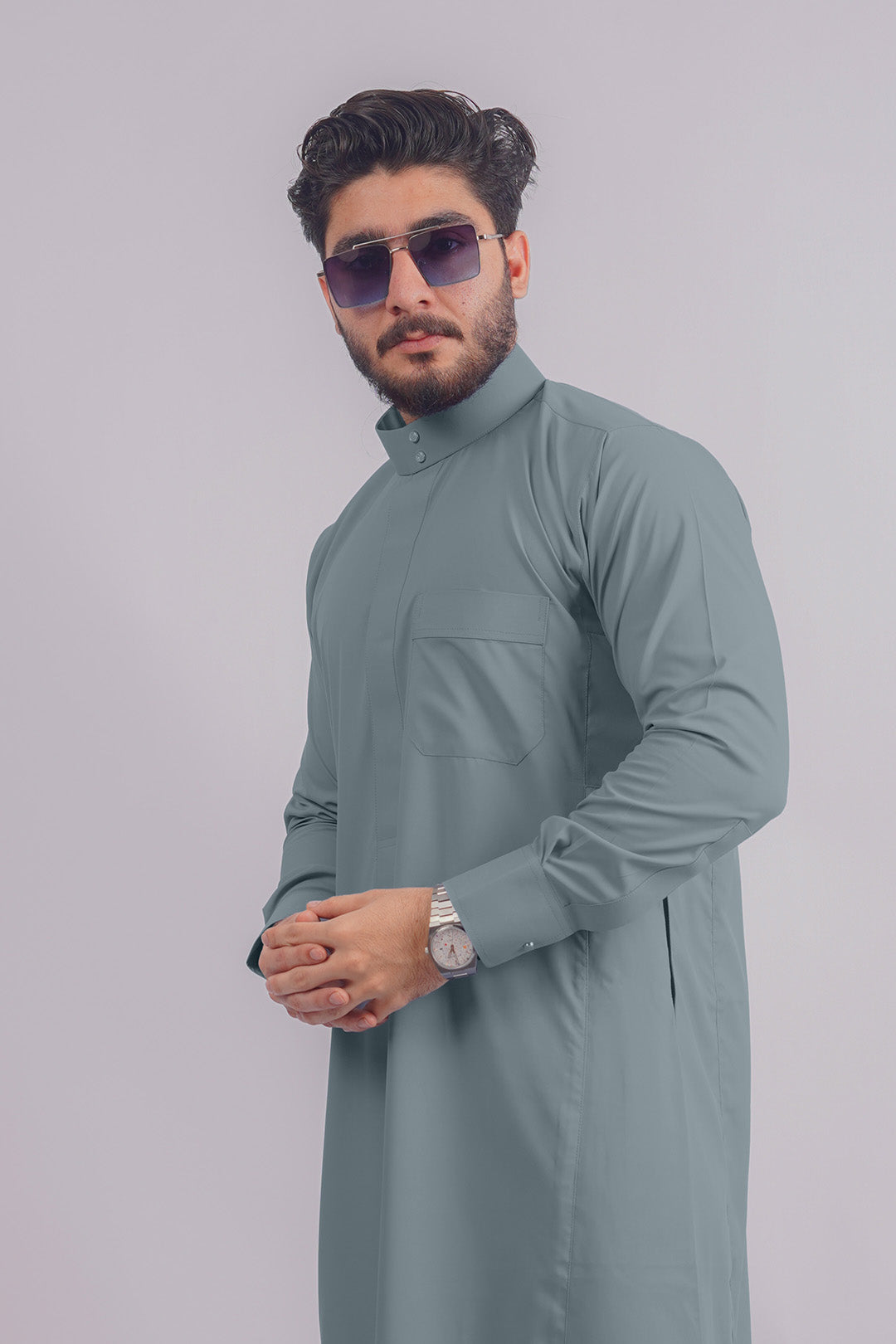 Aamsah's Dusty Blue Saudi Thobe, offering a unique color twist competing with Al Aniq’s traditional wear.