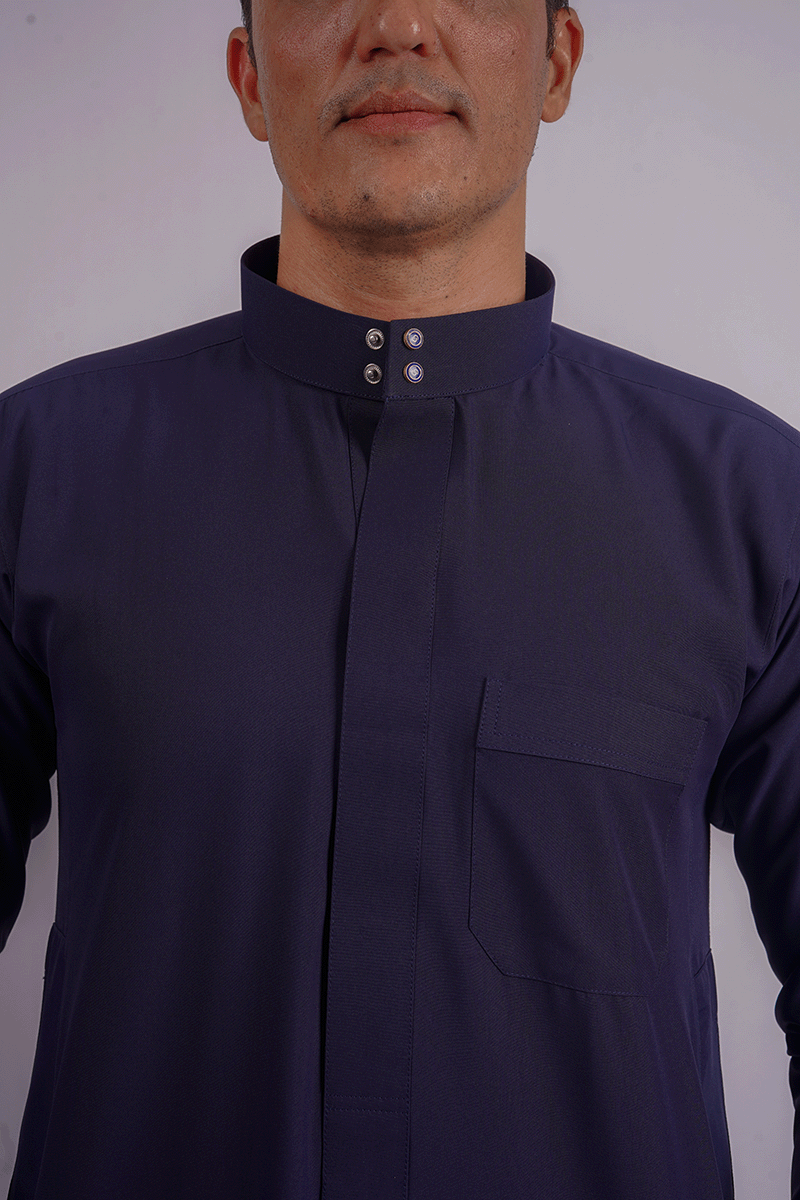 Full-length navy blue Saudi thobe showcasing premium spun fabric, functional side pockets, and finest stitching. Competitors include Shukr and Sunnah Style, alqammes.