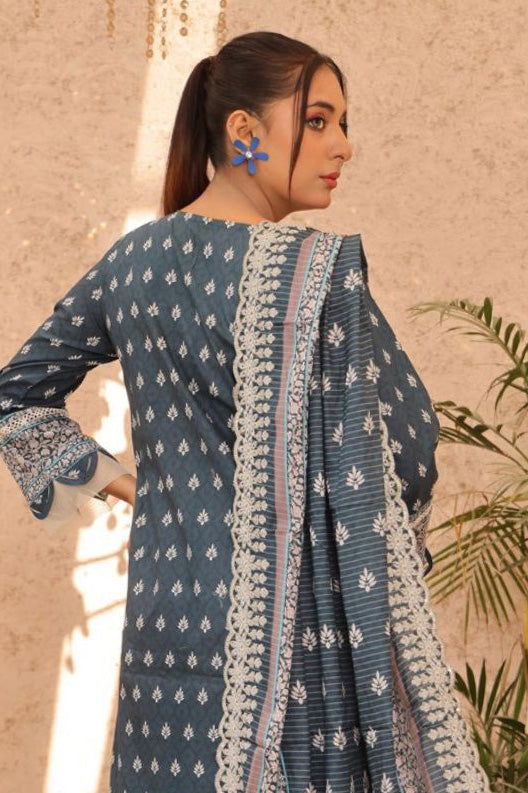 Lawn set for women in deep green with floral accents and embroidered trousers, perfect for modern Pakistani wear. Competing with Cross Stitch and Fabricoz.