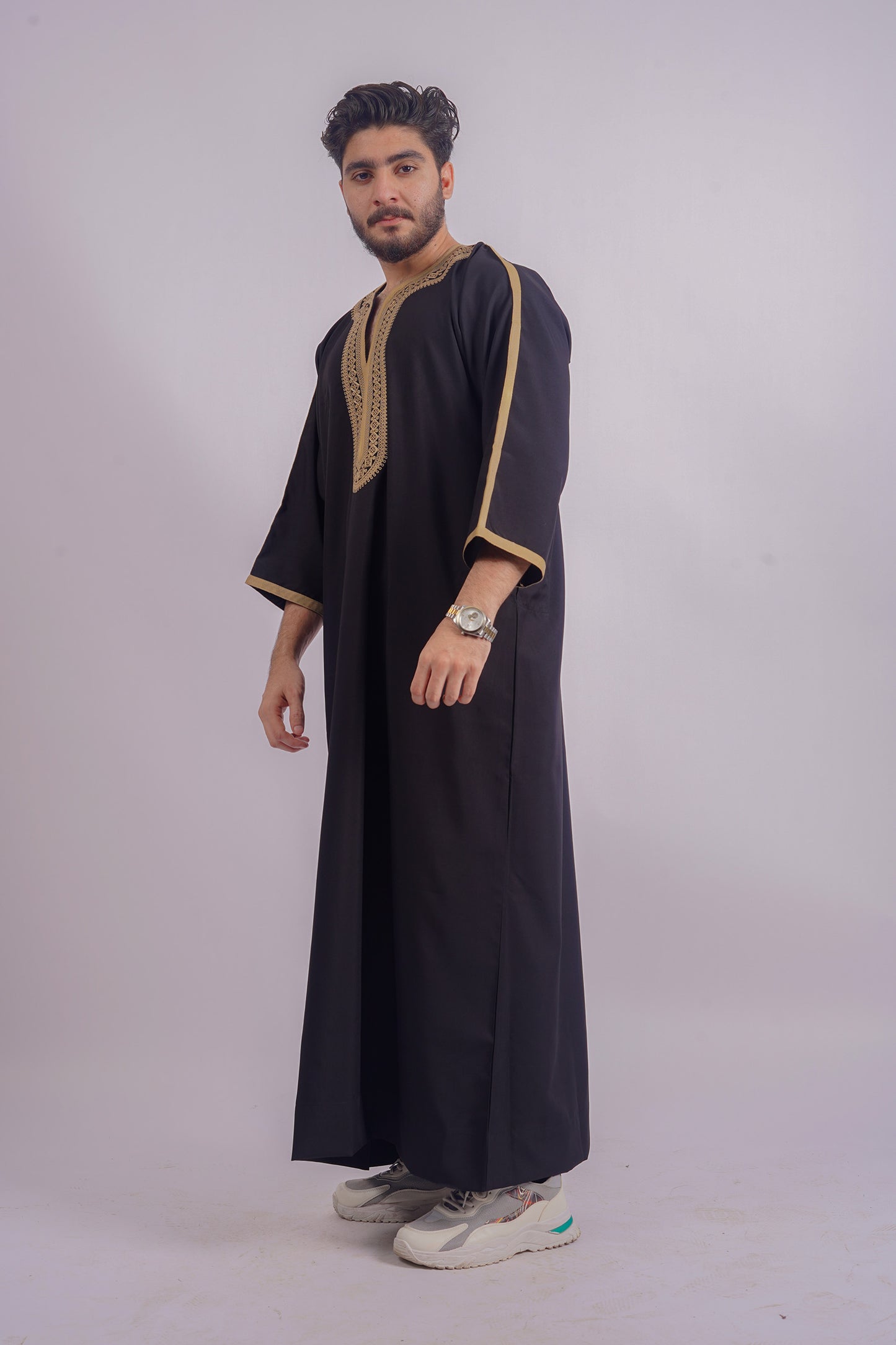 Aamsah's Black Thobe with Golden Detailing offers a majestic look comparable to MuslimAmerican.com, suited for religious celebrations and daily elegance.