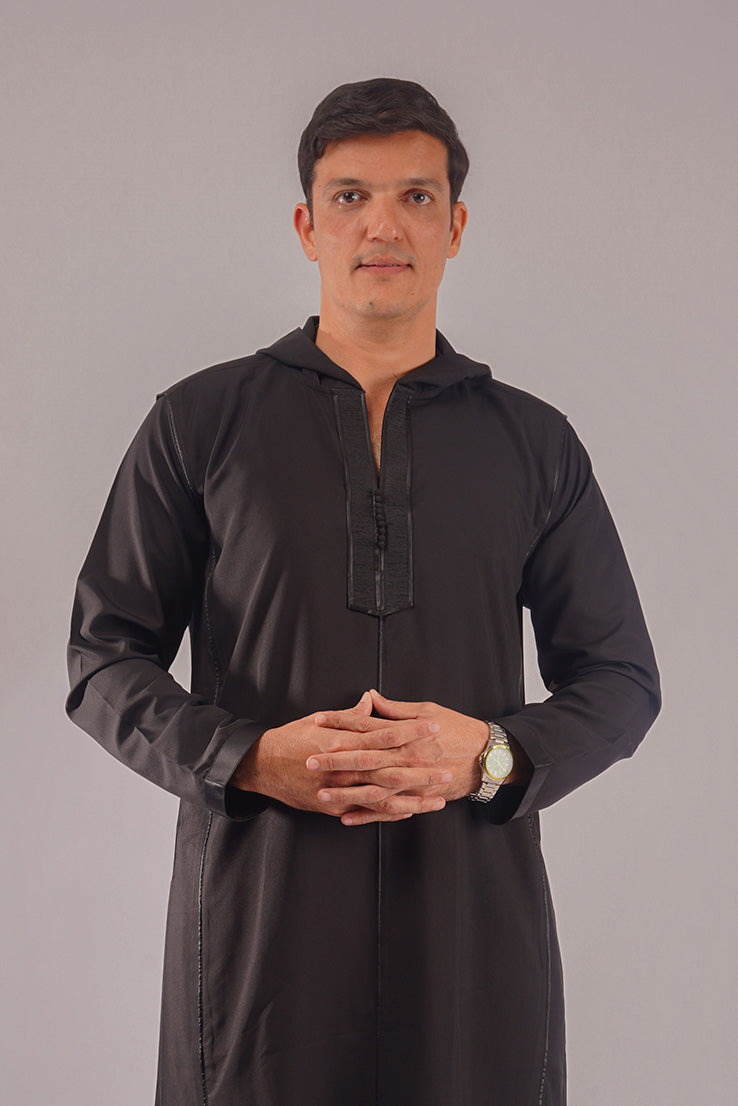 Man wearing Aamsah's Hooded Black Thobe, offering a stylish alternative to similar styles from Alqamees and MuslimAmerican.com.