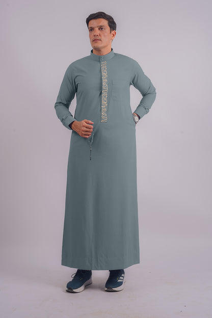 Aamsah's Dusty Blue Saudi Thobe with Golden Embroidery, blending modern style with classic Saudi elements, perfect for weddings and religious gatherings.