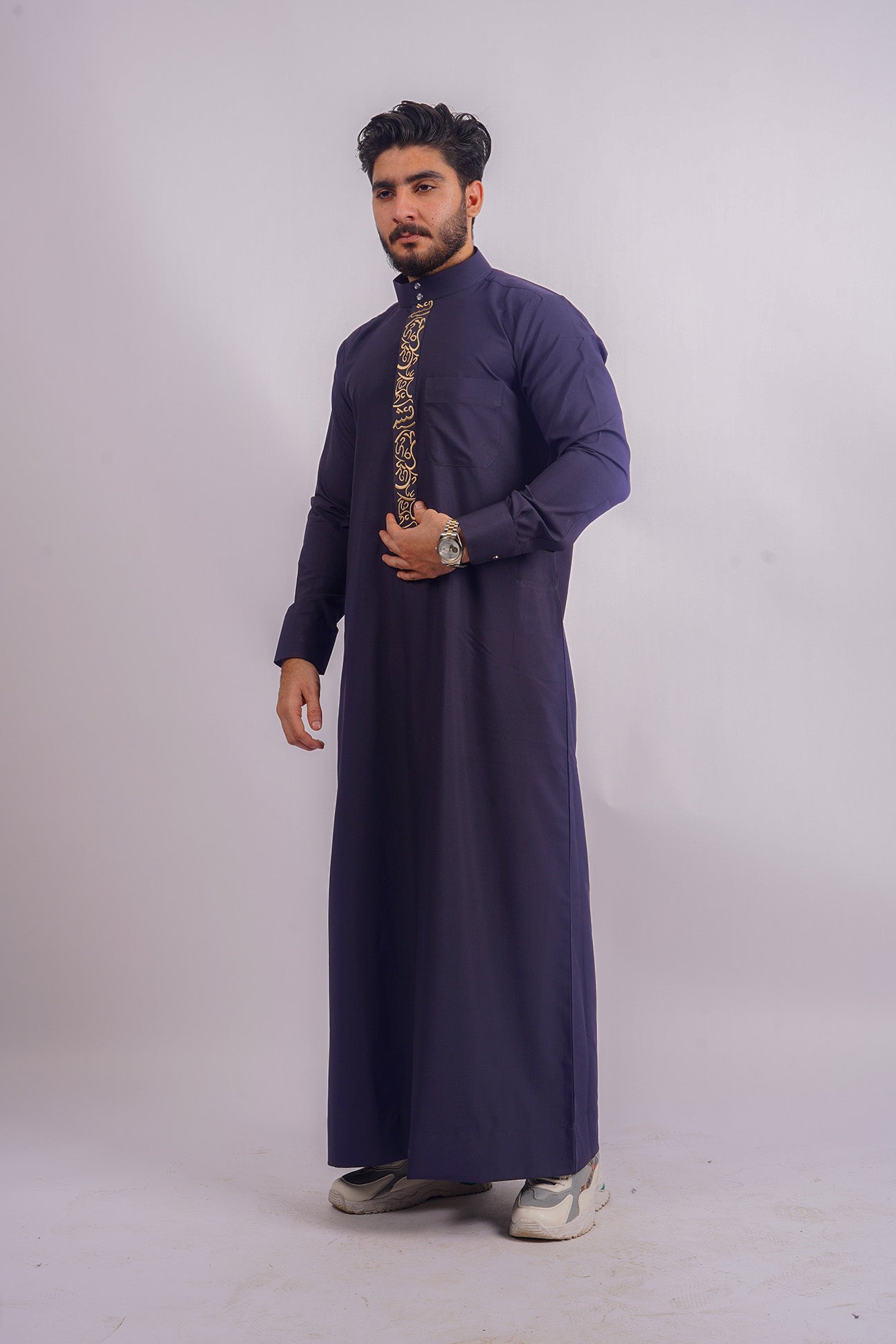 Aamsah's Navy Blue Saudi Thobe, showcasing traditional elegance with a contemporary edge, comparable to styles from Al Aniq and MuslimLifestyleStore.com.
