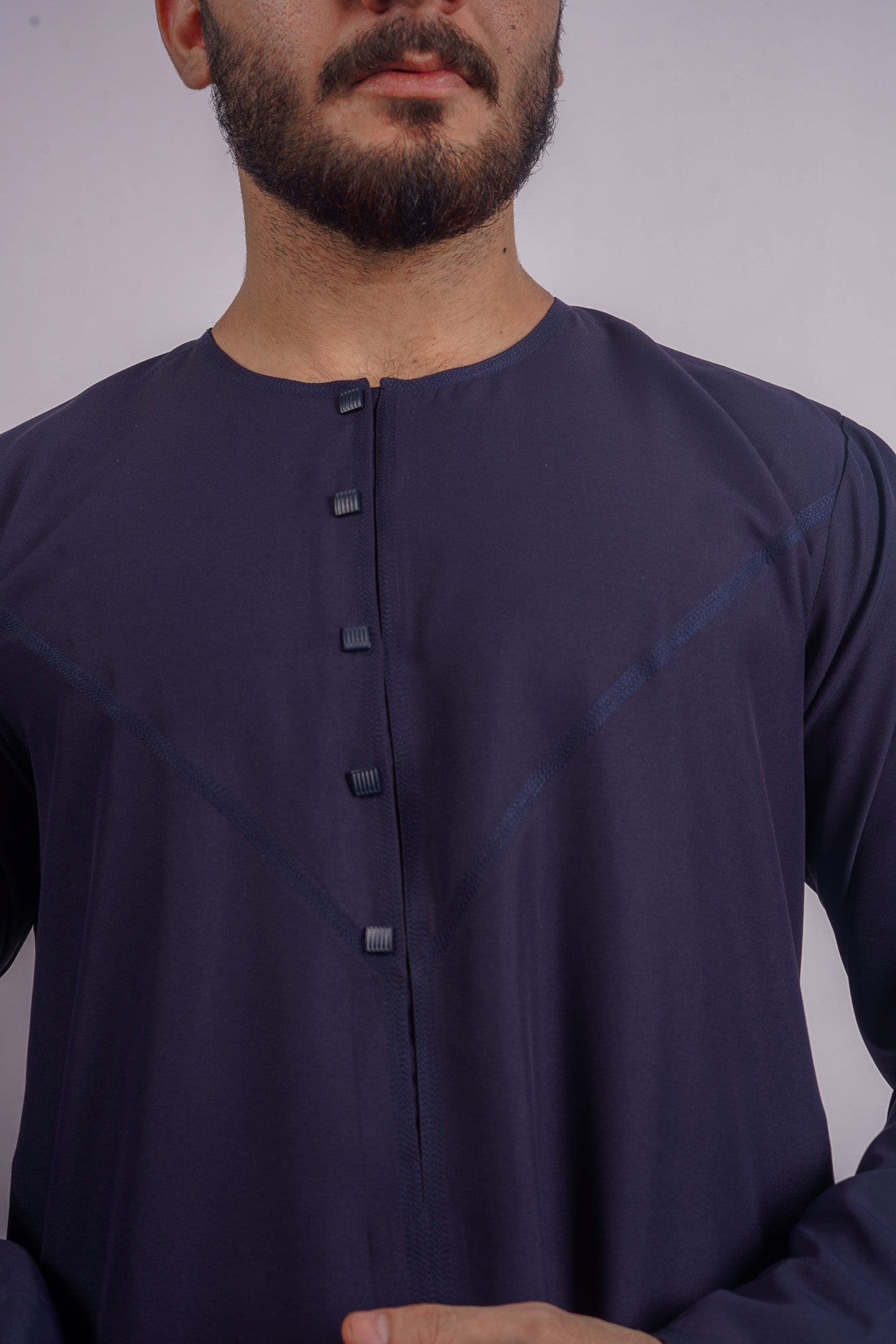 Aamsah’s Navy Blue Qamis, merging Emirati craftsmanship with contemporary style, a sophisticated alternative to offerings from Al Aniq.