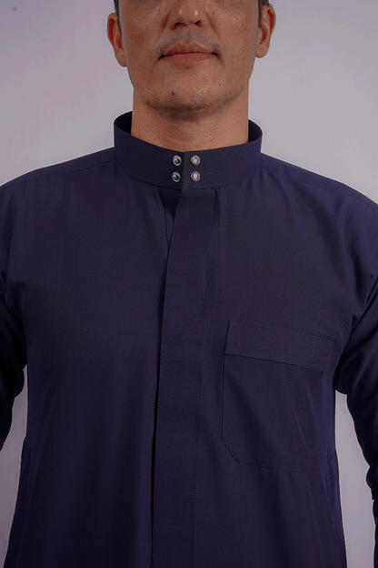 Full-length navy blue Saudi thobe showcasing premium spun fabric, functional side pockets, and finest stitching. Competitors include Shukr and Sunnah Style, alqammes.