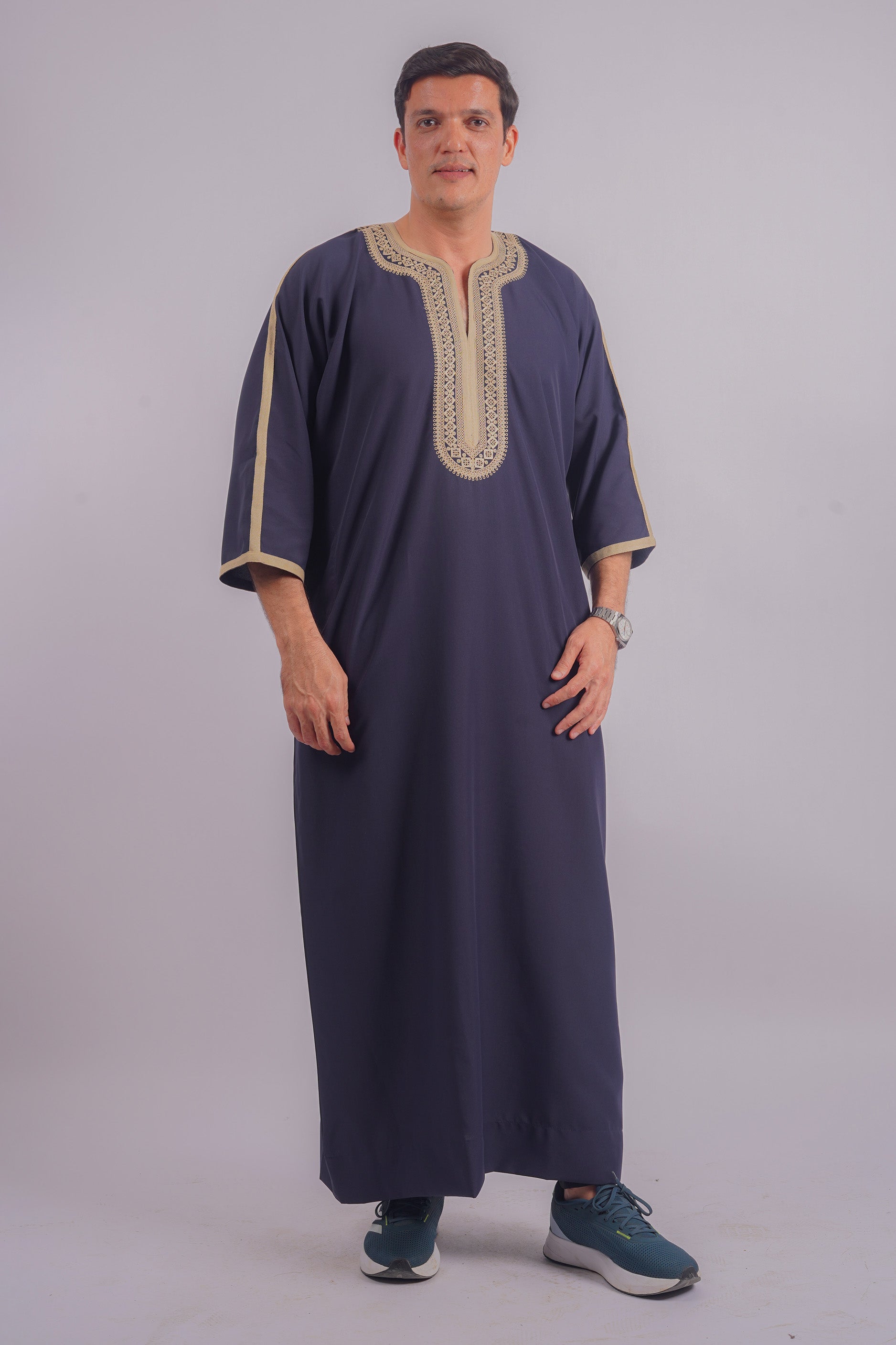 Shop Aamsah’s refined Navy Blue Qamis, adorned with golden embroidery, matching the quality of bespoke cultural attire.