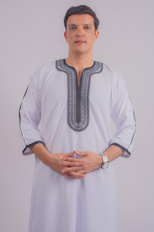 Shop Aamsah's elegant white Dishdasha with black embroidery, comparable to MuslimAmerican.com, perfect for Islamic ceremonies and daily wear.