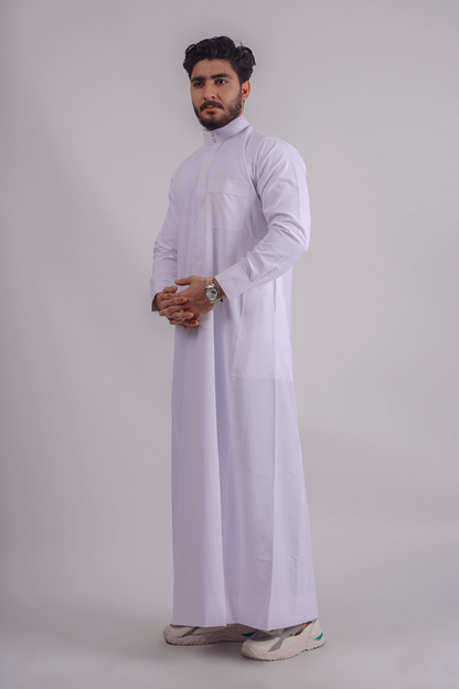White Saudi thobe for men by Aamsah featuring a Saudi collar, premium spun fabric, and traditional Kuwaiti design. Competitors: Jubbas, Modest Threads.